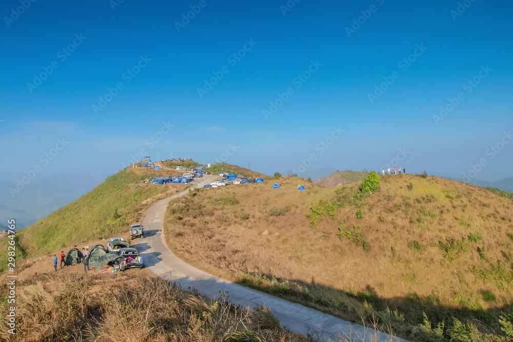 view of tourists camping on side way up to top hill with blue sky background, Nern Chang Suek, Thong Pha Phum, Kanchanaburi, Thailand.
