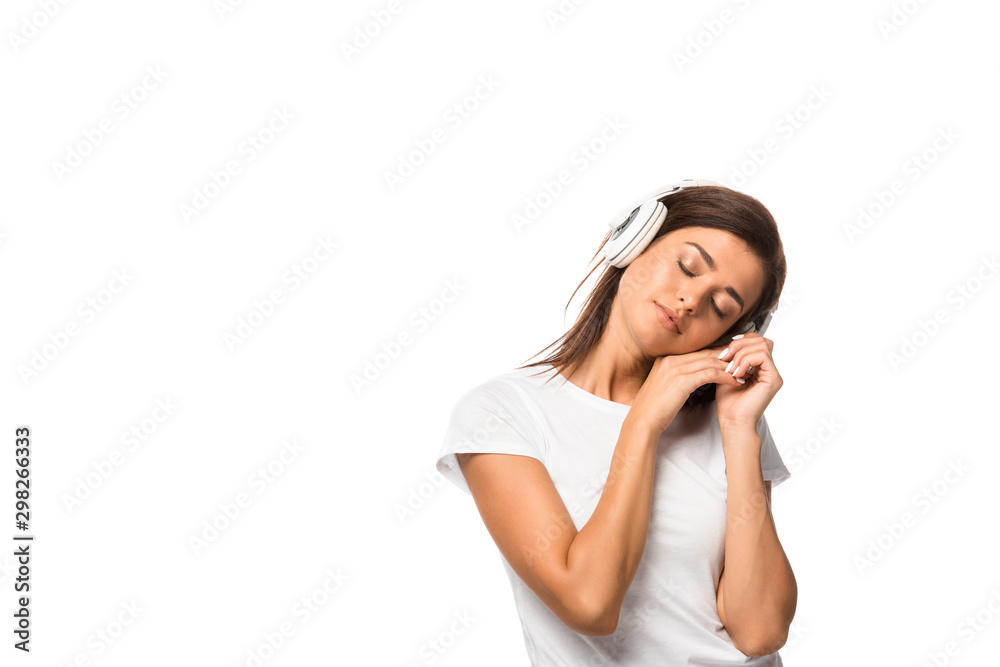 Fototapeta premium beautiful sleepy woman with closed eyes listening music with headphones, isolated on white