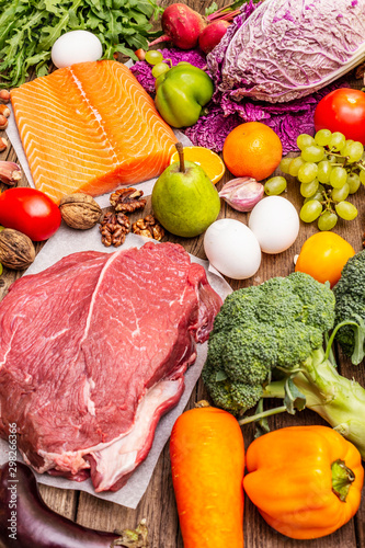 Fototapeta Naklejka Na Ścianę i Meble -  Trending paleo/pegan diet. Healthy balanced food concept. Set of fresh products, raw meat, salmon, vegetables and fruits