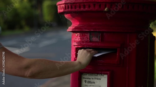 Posting Letter Into English Red Post Box By Road White Female 