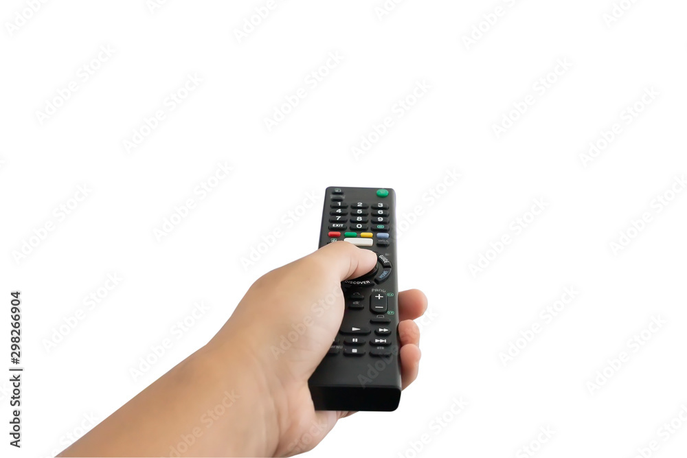 The hand is pressing the remote control to select the channel on white background. The hand is pressing the remote control to select the channel on white background.