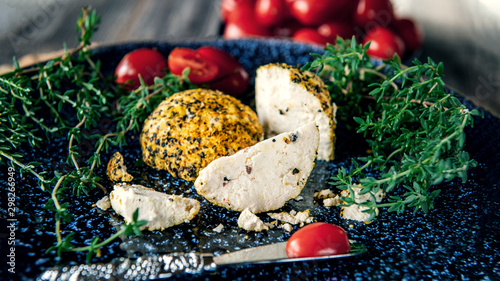 Cheese belper knolle in spices red and black pepper and Provencal herbs. Little homemade balls of cheese Belper.Delicacy round small cheese with black pepper and garlic. Belper Knoll. photo