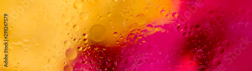 Soft focus abstract background with circles and balls. Bright yellow, red, pink colors. Horizontal banner