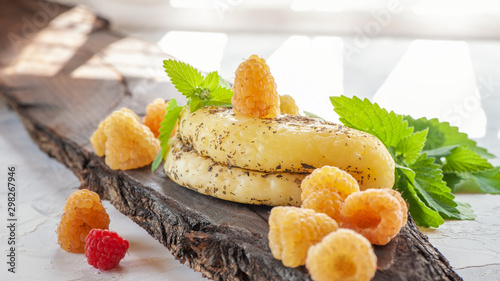Halloumi cheese with yellow raspberries. Unconventional serving of halloumi cheese. Farm natural product