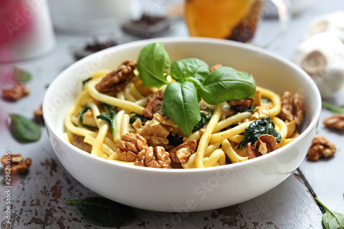 Spaghetti in a cream sauce with fresh spinach, garlic walnuts
