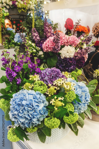 Bouquet of beautiful purple and white hydrangeas with eustoma flowers and colorful inflorescences Delphinium . Modern trends in floriculture. decoration of residential premises with flowers