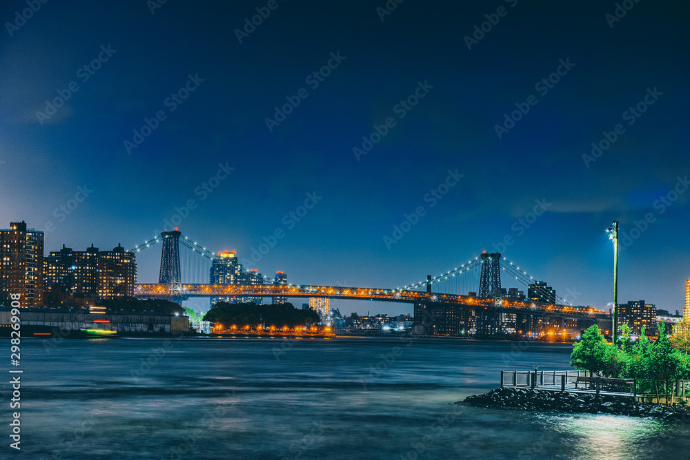 New York night view of the Lower Manhattan and the Manhattan Bridge across the East River.