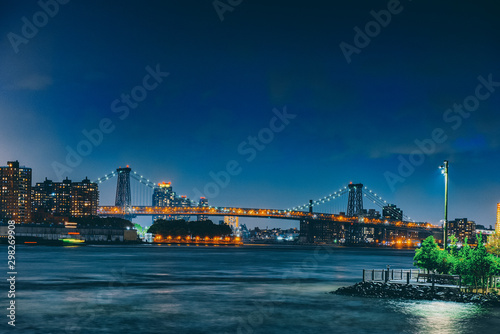 New York night view of the Lower Manhattan and the Manhattan Bridge across the East River.