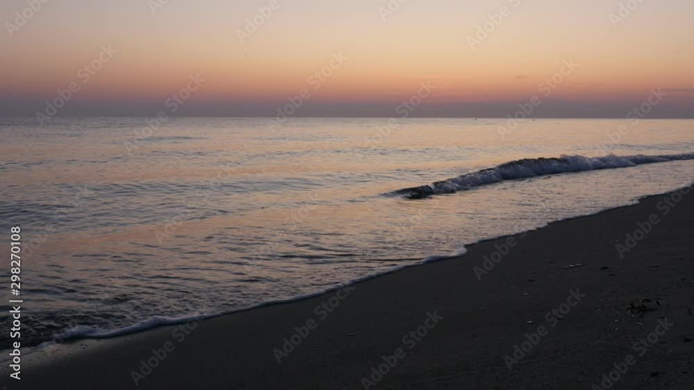 Sea scenery before sunrise with orange tones of sky 4K video Sea scenery before sunrise with orange tones of sky 4K video