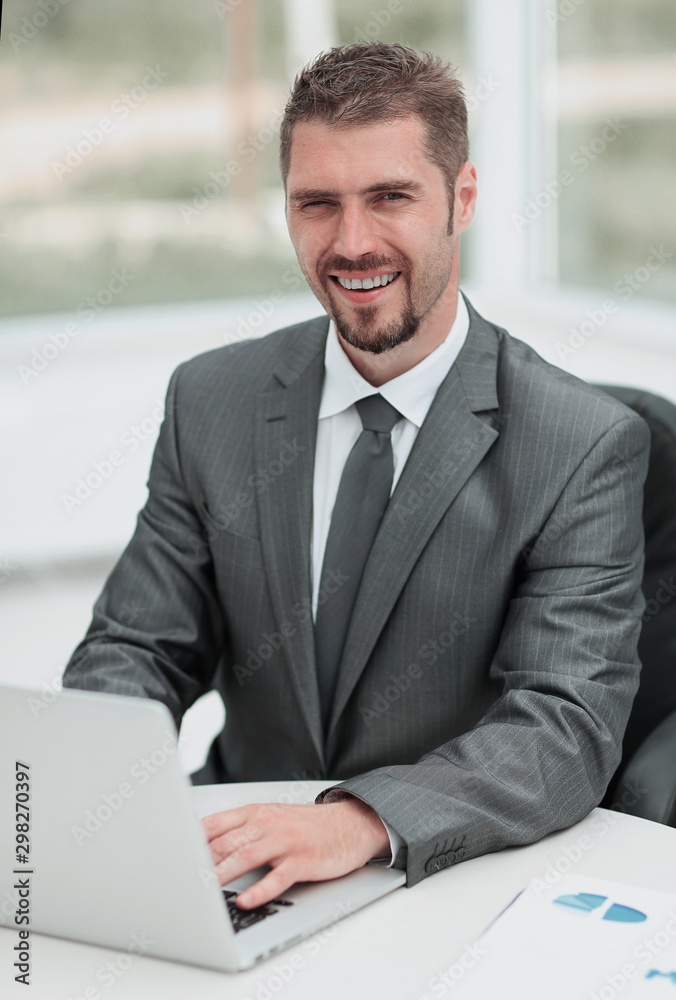 closeup.smiling businessman working with laptop closeup.smiling businessman working with laptop