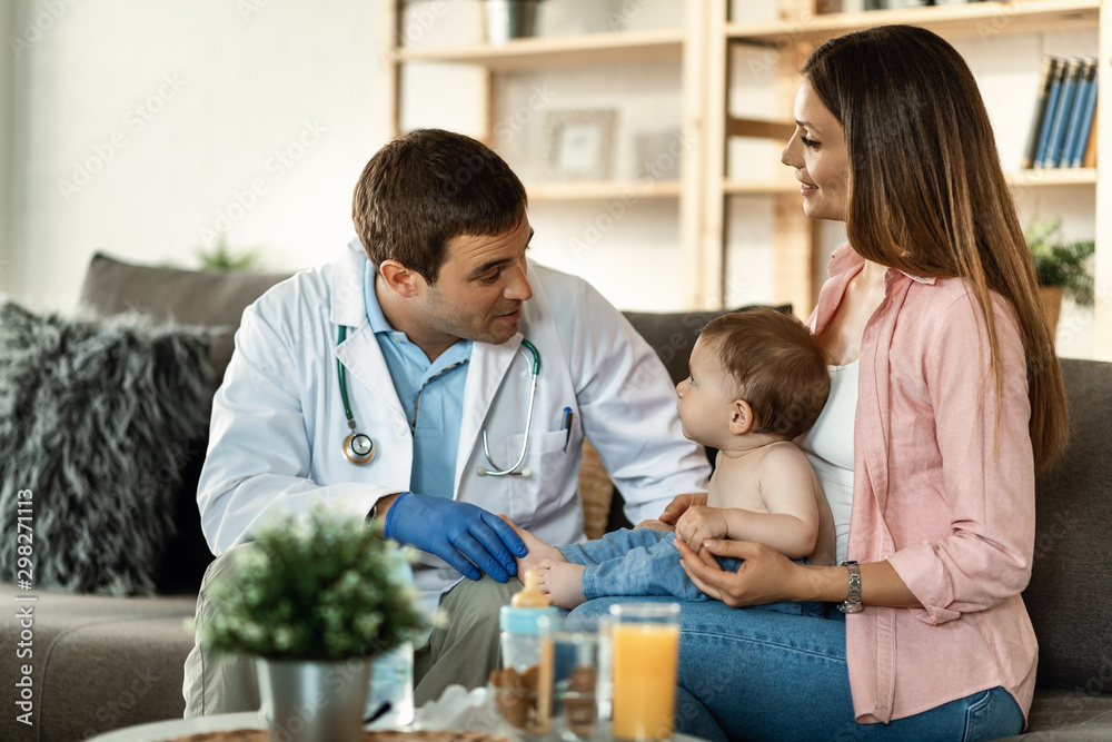 Male pediatrican talking to small boy and his mother during the appointment. Male pediatrican talking to small boy and his mother during the appointment.
