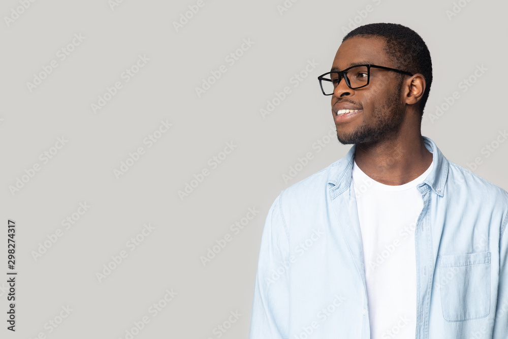 Smiling African American man in glasses looking at copy space Smiling African American man in glasses looking at copy space