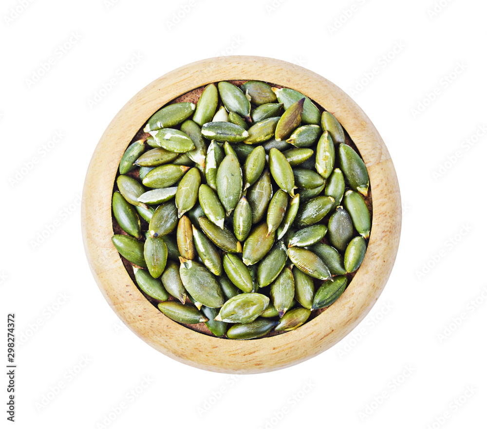 Dired pumpkin seeds i wooden dish. Dired pumpkin seeds i wooden dish.