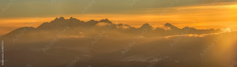 Beautiful winter landscape with a view of the Tatra Mountains at sunset