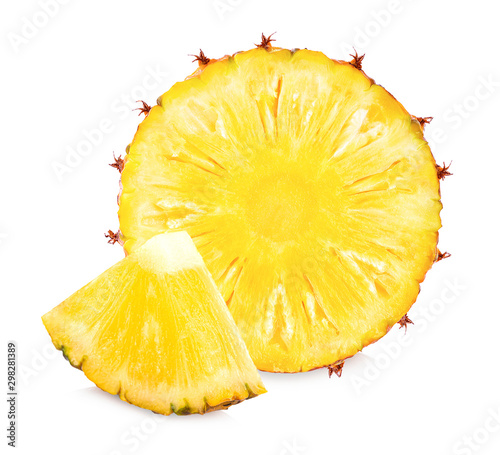 Fresh pineapple slices and pineapples, split in half on a white background