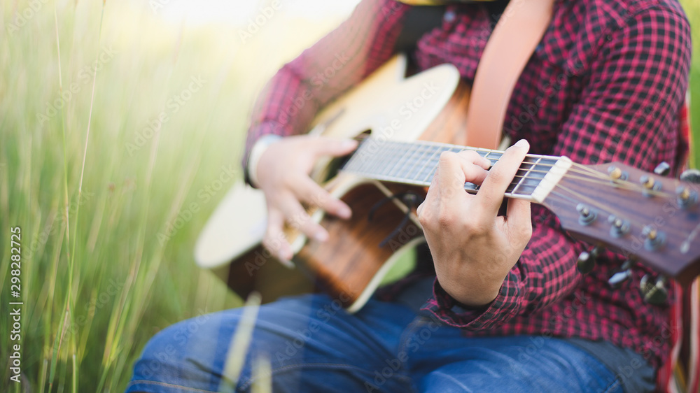 Music in nature, People playing guitar in lawn, Close-up
