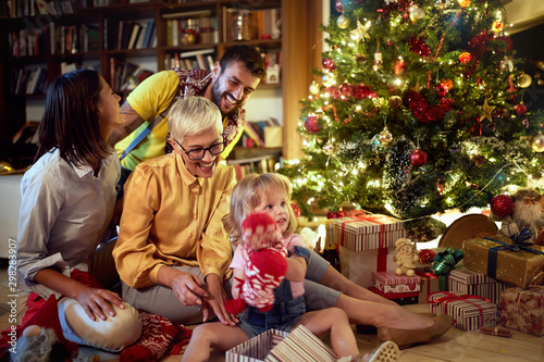 Cheerful grandmather and little girl together for Christmas photo