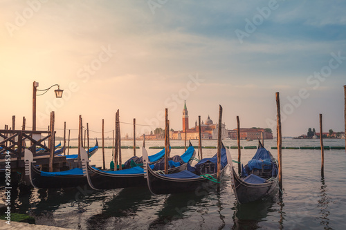 Gondolas on the pier. Cathedral of San Giorgio Maggiore on the background. Yearly Venetian morning © OlgaKhorkova