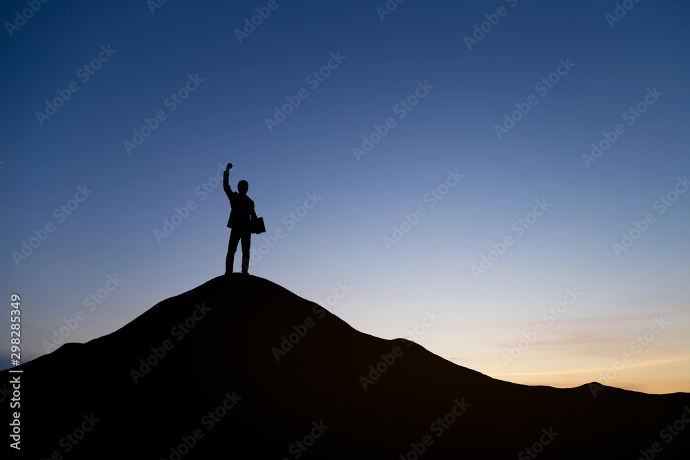 Silhouette of businessman raising his hand to celebrate success on top of mountain, White background.