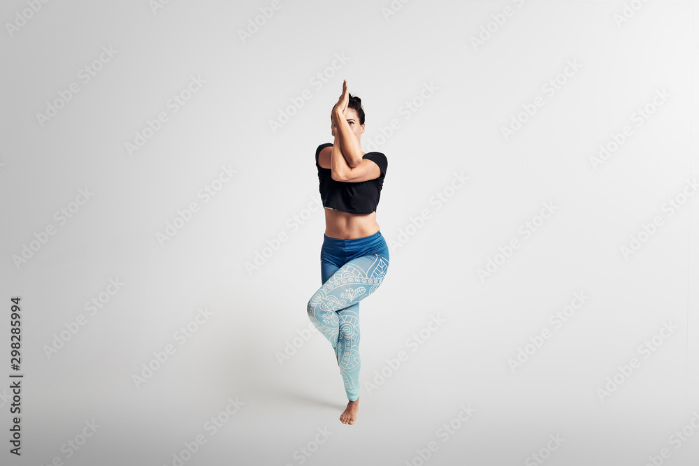 Eagle pose, yoga pose, woman on white background, frontal Eagle pose, yoga pose, woman on white background, frontal