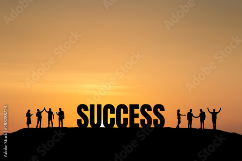 Silhouette group of business people are celebrating success at sunlight background. Business and goal concept.