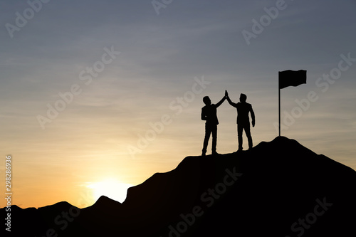 Silhouette of businessman are celebrating success at sunlight background. Business and goal concept.