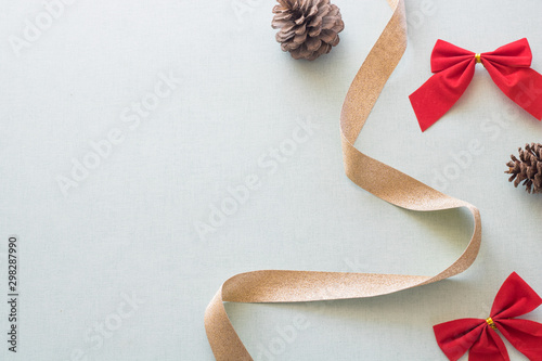Christmas background with gift boxes, pine cone and decorations on light blue background. Preparation for holidays. Top view with copy space.