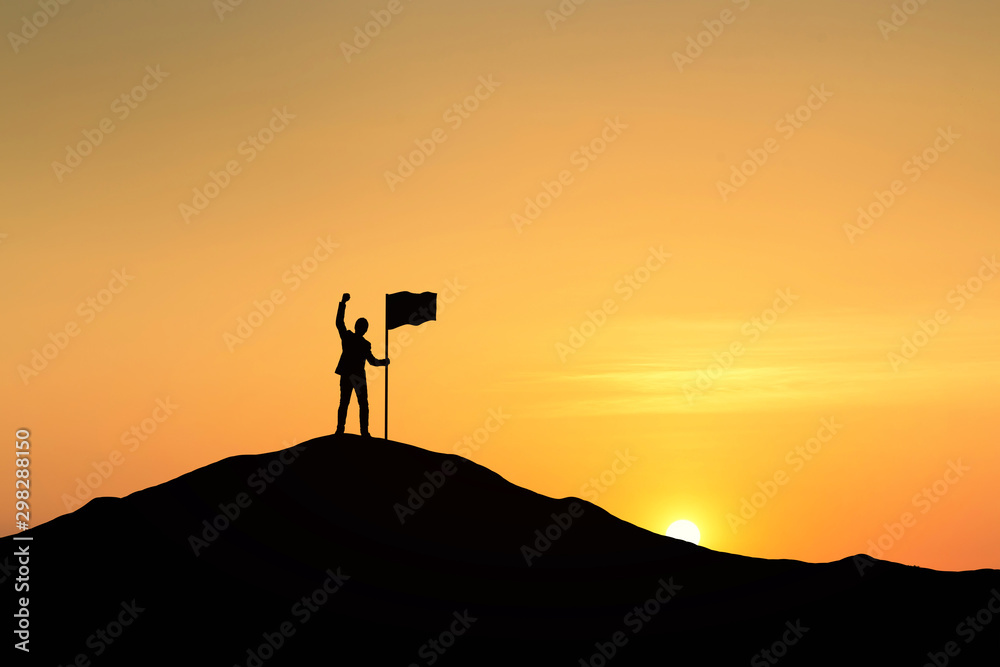 Silhouette of people and flag on top mountain, sky and sun light background. Business success and goal concept.