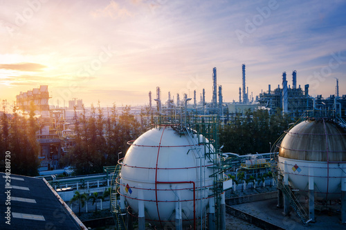 Gas storage sphere tanks in oil and gas refinery plant with sunset sky background photo