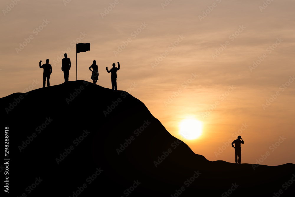 Silhouette of successful team and team that failed at sunset background.