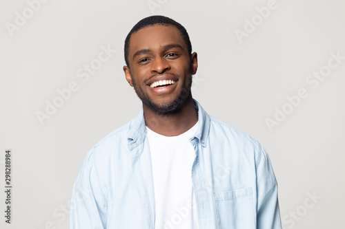 Head shot portrait happy African American man with healthy smile photo