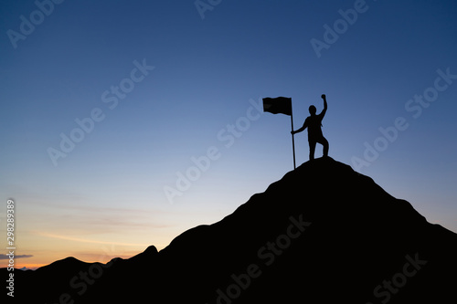 Silhouette of people and flag on top mountain, sky and sun light background. Business success and goal concept.