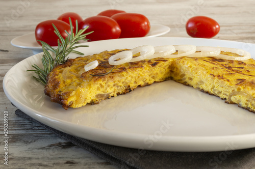 frittata di uova con le cipolle tagliata dal basso e pomodori photo