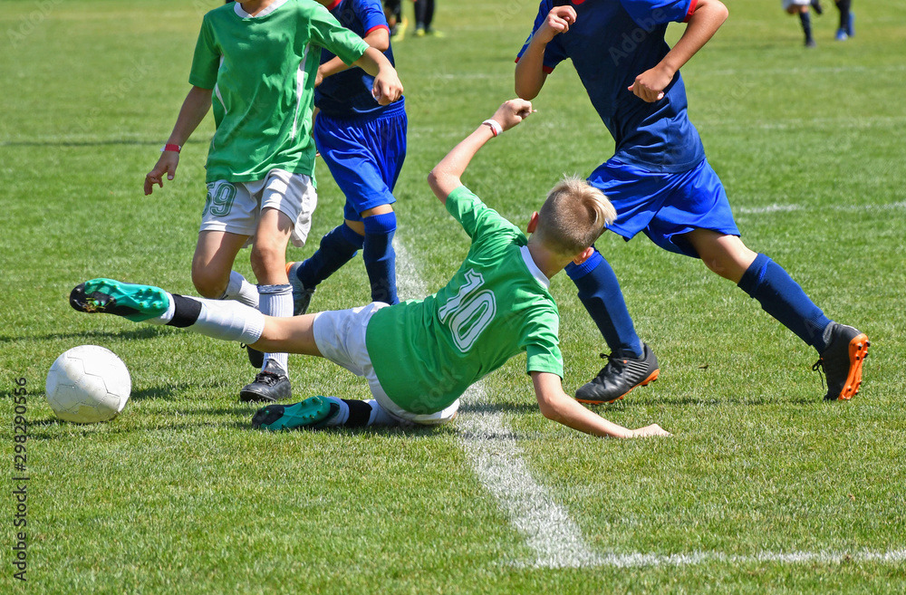 Young kids are playing soccer in summer time Young kids are playing soccer in summer time