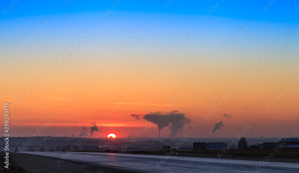 Silence on the winter highway, to the Yoshkar-Ola city. Panoramic view of Yoshkar-Ola city at sunset. Twilight time.