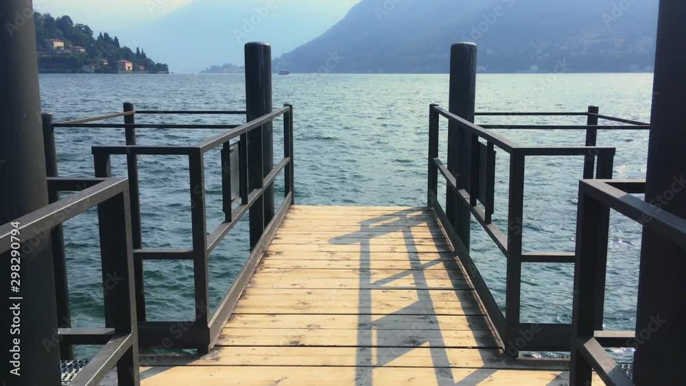 cernobbio pier walkway on como lake while camera moves forward. Point of view shot