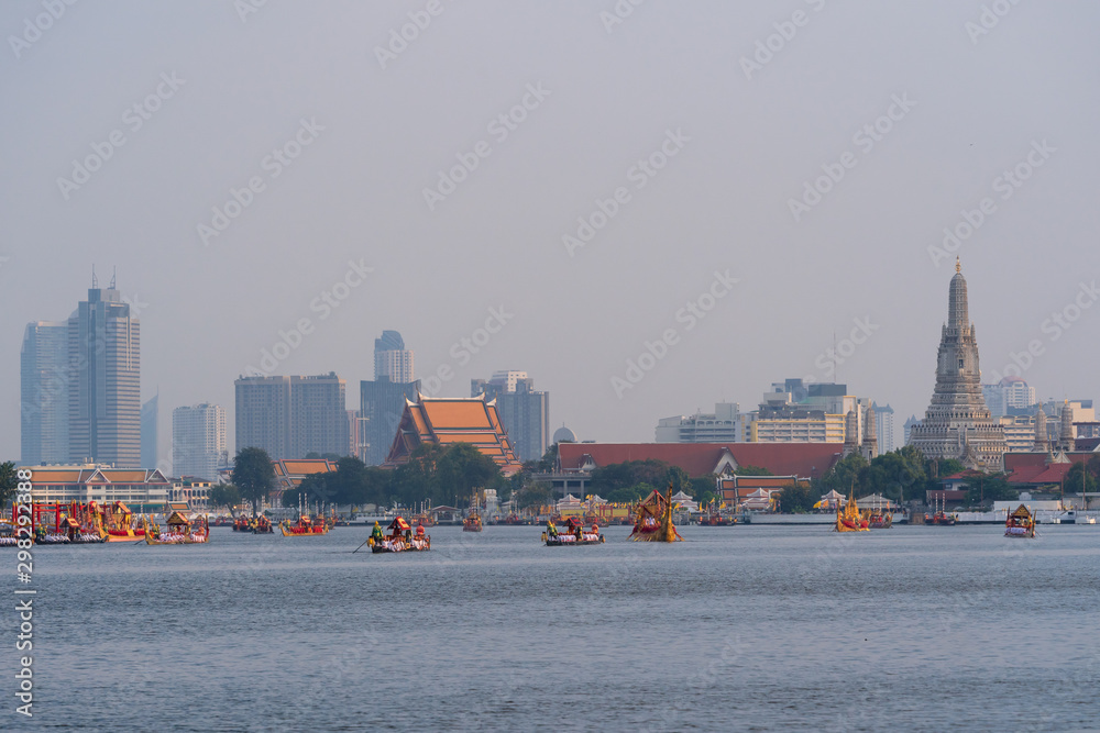 Traditional Royal Thai barge boat on Chao Phraya River with Wat Arun temple is famous place the travel destination background in Bangkok city Thailand