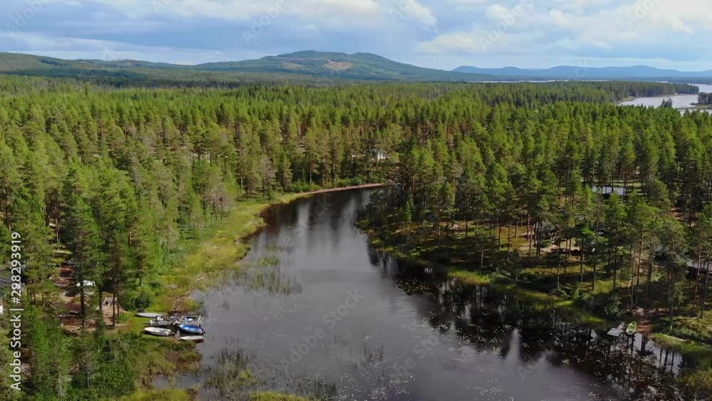 Aerial over the rivers and heavily forested areas of Dalarna County in Sweden. Drone slow forward dolly Aerial over the rivers and heavily forested areas of Dalarna County in Sweden. Drone slow forward dolly
