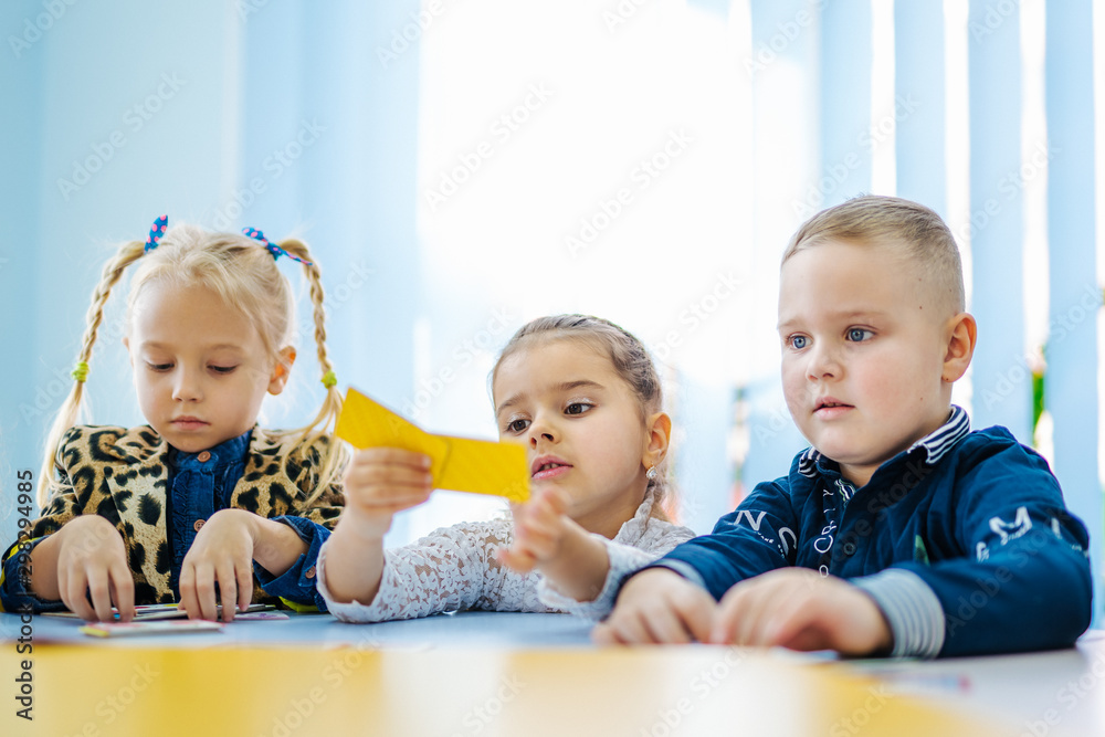 Preschoolers sitting at the table in classroom. Preschoolers sitting at the table in classroom.