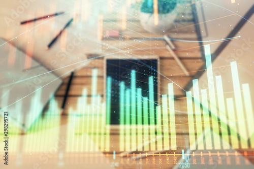 Double exposure of forex graph on digital tablet laying on table background. Concept of market analysis