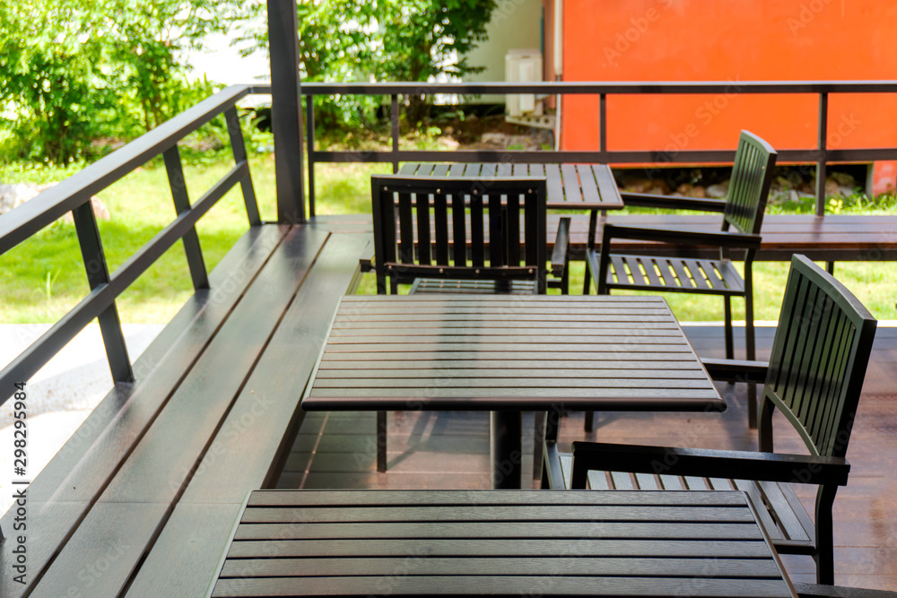 Oak color table and chairs are located on the terrace outside of the building, for guests to relax or eat