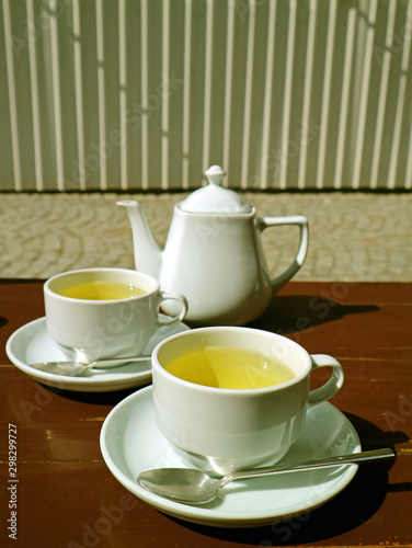 Vertical image of a tea set on the table at outdoor seating