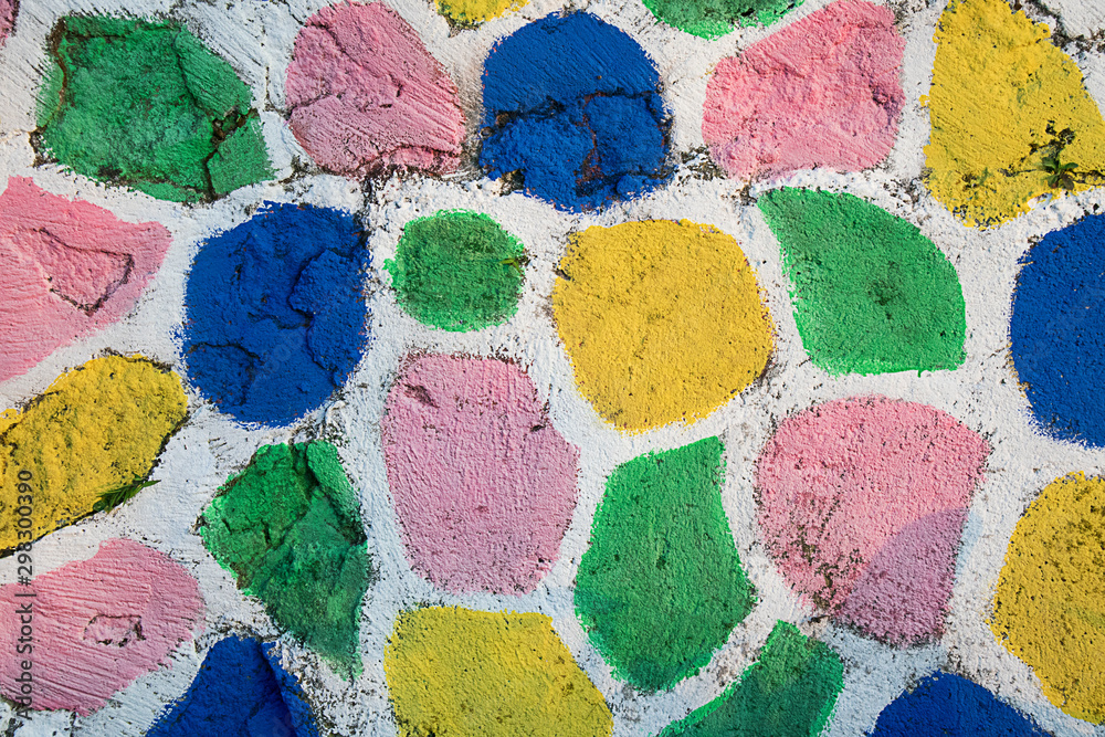 stone walls painted in bright colors, consisting of blue, purple, yellow and white as a dividing line stone walls painted in bright colors, consisting of blue, purple, yellow and white as a dividing line