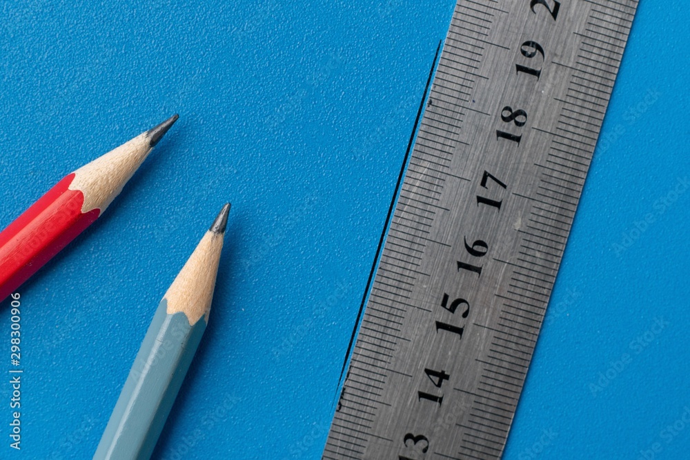drawing a line on a color surface with a ruler and pencil drawing a line on a color surface with a ruler and pencil