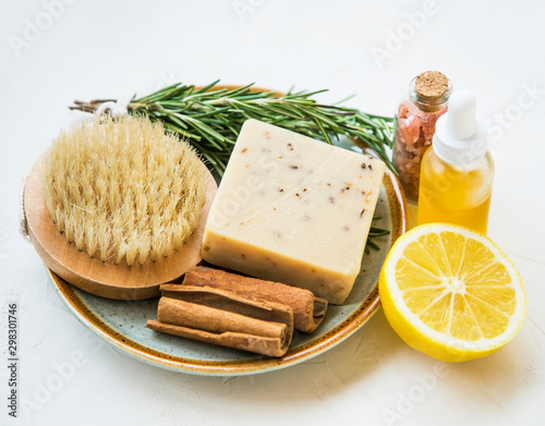 Clean beauty. Natural spa products with rosemary herb, lemon, oil bottle,natural cinnamon soap and brush, natural home skincare products, homespa and wellness clean beauty products photo