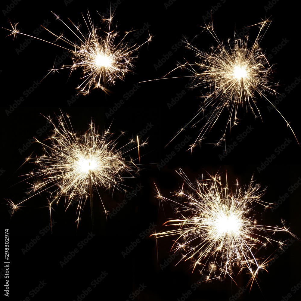 Set of four bright burning sparklers on a black background