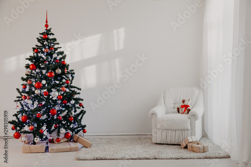 Christmas tree in a white room for Christmas with gifts photo