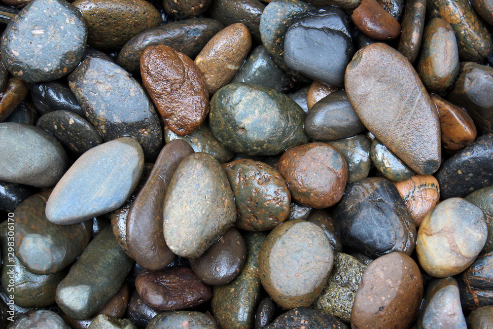 Dark brown and gray sea pebbles as a background Dark brown and gray sea pebbles as a background