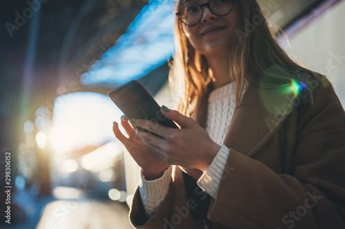 Woman holding in hands mobile phone on platform station. Close up technology smartphone online connect. Girl travel waiting train using gadget cellphone. Digital wifi internet lifestyle mockup