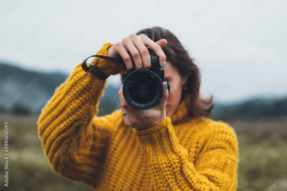 photographer girl take photo on camera closeup on background autumn foggy mountain, tourist shooting nature mist landscape, hobby concept, copy space